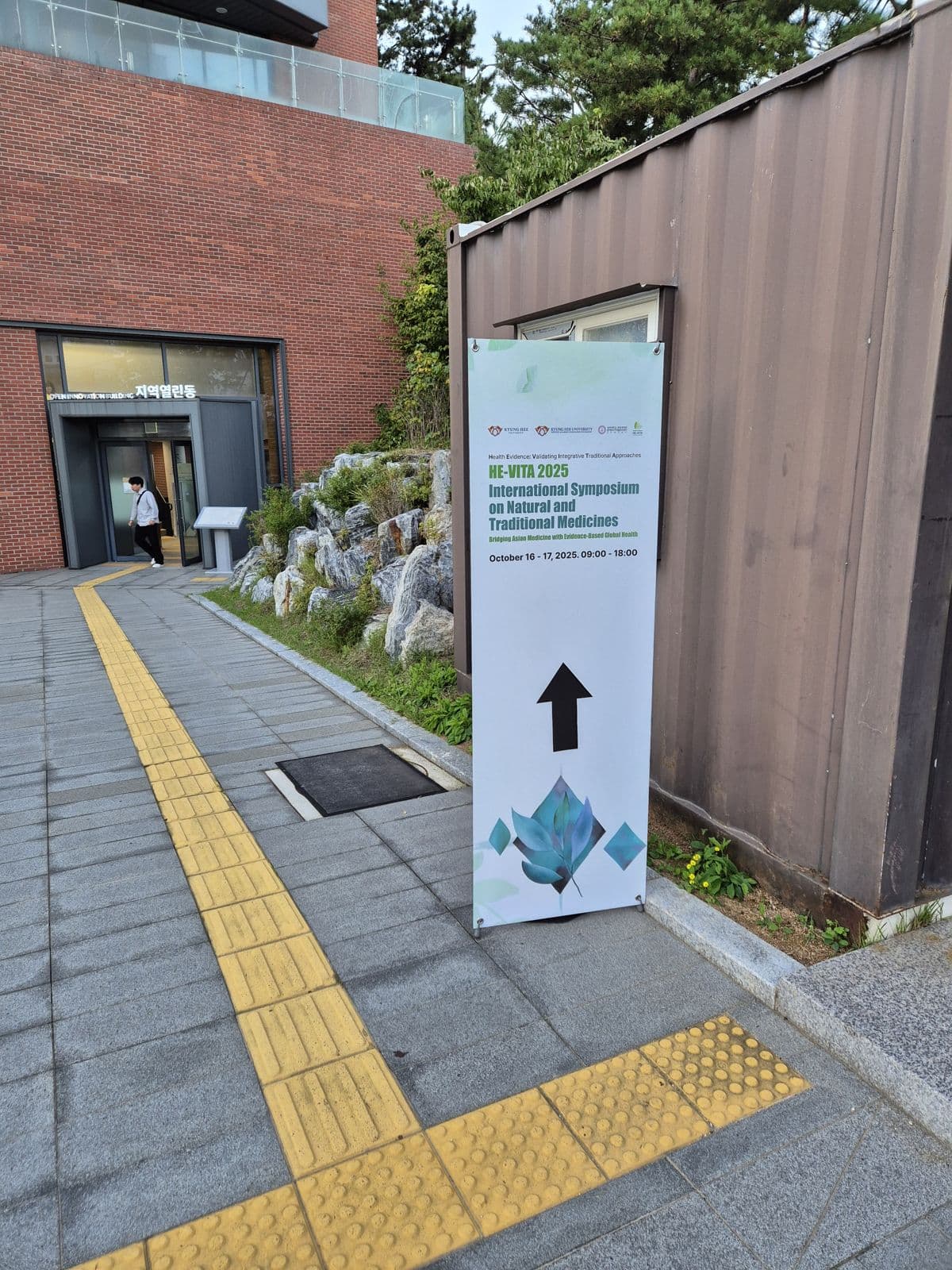 HE-VITA 2025 signboard pointing towards the symposium venue